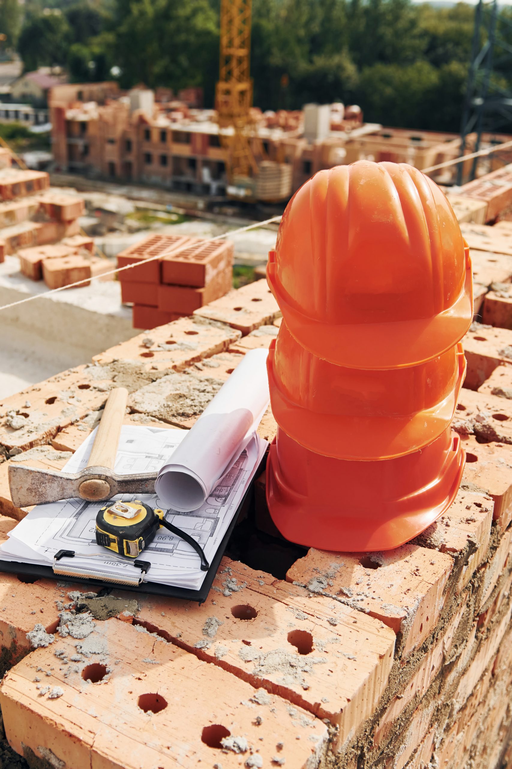 Close up view of protective hard hats that laying down on the bricks.